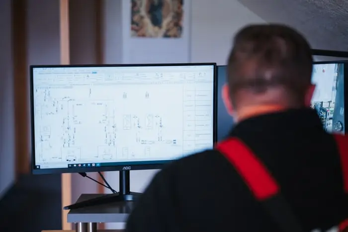 Mitarbeiter vor einem Monitor bei der Planung einer Anlage